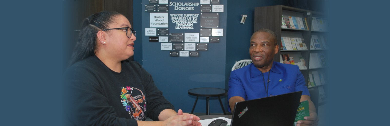 NWC Registrar Olu working with a student